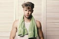 Man with green towel around neck. Athlete with strong muscles after morning shower. Exercising and healthy lifestyle