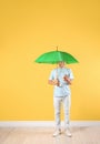Man with green umbrella and smartphone