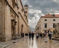 A man greets tourists at the opening gate on the streets of Old Town, the famous landmark in Dubrovnik, Croatia. Royalty Free Stock Photo