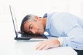 Man with grey hair sleeping on his laptop Royalty Free Stock Photo