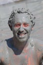 Man in grey mud bath. Dalyan, Turkey