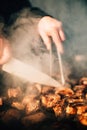 Man grilling food on a barbecue in a backyard setting Royalty Free Stock Photo