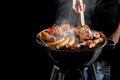 Man grilling meat on a portable barbecue Royalty Free Stock Photo