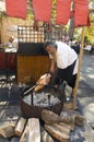 Man grilling a pice of meat on the medival market Royalty Free Stock Photo