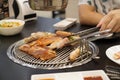 A man grilling porks,on Charcoal grilled Korean-Style BBQ.