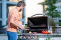 Man grilling steaks to perfection on smoky barbecue. Barbecue cooking prowess. Grilling man cook meat at barbecue