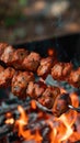 Man grills shish kebab over flames, sizzling with deliciousness