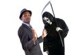 Man in Grim Reaper Ghost Costume Playing a Prank on Halloween