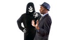 Man in Grim Reaper Ghost Costume Playing a Prank on Halloween