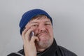 A man grimaces while talking on his cell phone Royalty Free Stock Photo