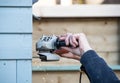 Man with a grinder cutting wood