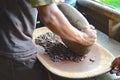 Man grinding cacao beans Royalty Free Stock Photo