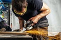 Man grinding metal with a angle grinder Royalty Free Stock Photo