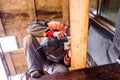 Man grinding planks of wood for home construction. Royalty Free Stock Photo