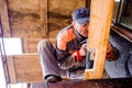 Man grinding planks of wood for home construction. Royalty Free Stock Photo