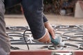 Man Grinds Metal Fence With Angle Grinder. Hands And Tool Close-up