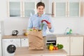 Man With Grocery Bag In Kitchen Room Royalty Free Stock Photo