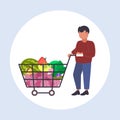 Man grocery shop customer pushing trolley cart with groceries vegetables and fruits male shopper buying products Royalty Free Stock Photo