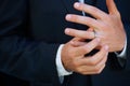 Man, groom and hands with ring for marriage, commitment or symbol of love, trust or care. Closeup of married male person