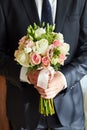 Man groom holds the Bridal bouquet. The groom meets the bride wi Royalty Free Stock Photo