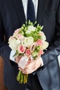 Man groom holds the Bridal bouquet. The groom meets the bride wi Royalty Free Stock Photo