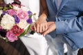 The man the groom keeps the girl`s hand. Colorful bridal bouquet. wedding day, bride accessories Royalty Free Stock Photo