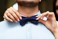 Man groom in wedding suit with bow tie. Hands bride, care, fix, adjust, fashion.