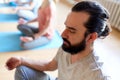 Man with group of people meditating at yoga studio Royalty Free Stock Photo