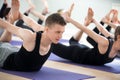 Man and a group of sporty people in Bow pose Royalty Free Stock Photo