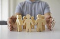 Man protects little human figures on table just like manager cares for team of people Royalty Free Stock Photo