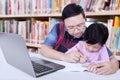 Man guide a girl to write on the book Royalty Free Stock Photo