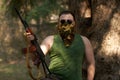 A Man With A Gun In A Forest