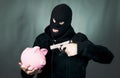 Man with a gun and piggy bank Royalty Free Stock Photo