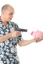 Man with gun pointing at piggy bank Royalty Free Stock Photo