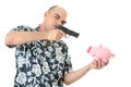 Man with gun pointing at piggy bank Royalty Free Stock Photo