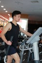 Asian chinese man in gym doing cardiovascular exercise