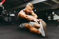 Man at the gym doing stretching exercises on the floor.Sports man at the gym doing stretching legs exercises