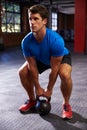 Man In Gym Exercising With Kettle Bell Weight Royalty Free Stock Photo