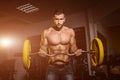 Man in gym. Muscular bodybuilder guy doing exercises with barbell. Strong person. Sports background. Young athlete ready Royalty Free Stock Photo