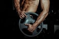 Man in gym. Muscular bodybuilder guy doing exercises with barbell. Strong person with Tense male hand with veins barbell
