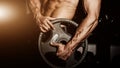 Man in gym. Muscular bodybuilder guy doing exercises with barbell. Strong person with Tense strong male hand with veins