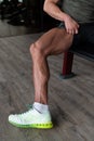 Man in Gym Showing His Well Trained Legs Close-up