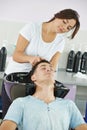 Man hair washing in hairdressing salon