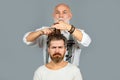 Man at the hairdresser getting a haircut. Hipster client in professional hairdressing salon. Professional barber styling Royalty Free Stock Photo