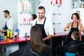 Man hairdresser talking to woman