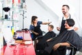 Man hairdresser talking to woman