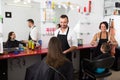 Man hairdresser talking to woman