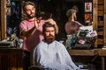 Man hairstylist. Beard man in barbershop. Hairstylist serving client at barber shop, bearded. Hairdresser, hair salon Royalty Free Stock Photo
