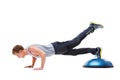 Man, half ball and push up in studio for fitness, core strength and workout challenge for wellness. Male person, athlete Royalty Free Stock Photo