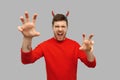 Man in halloween costume of devil scaring